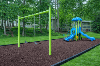 Community playground with swings and slide equipment